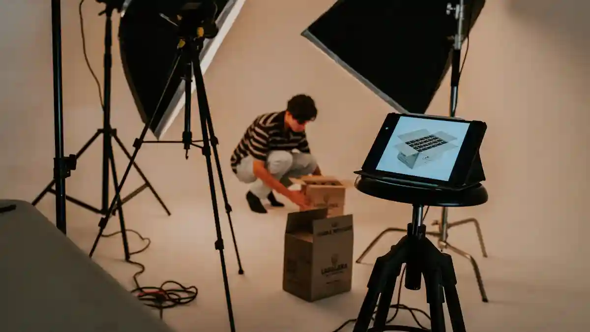 Photographer setting up product photography with tablet reference