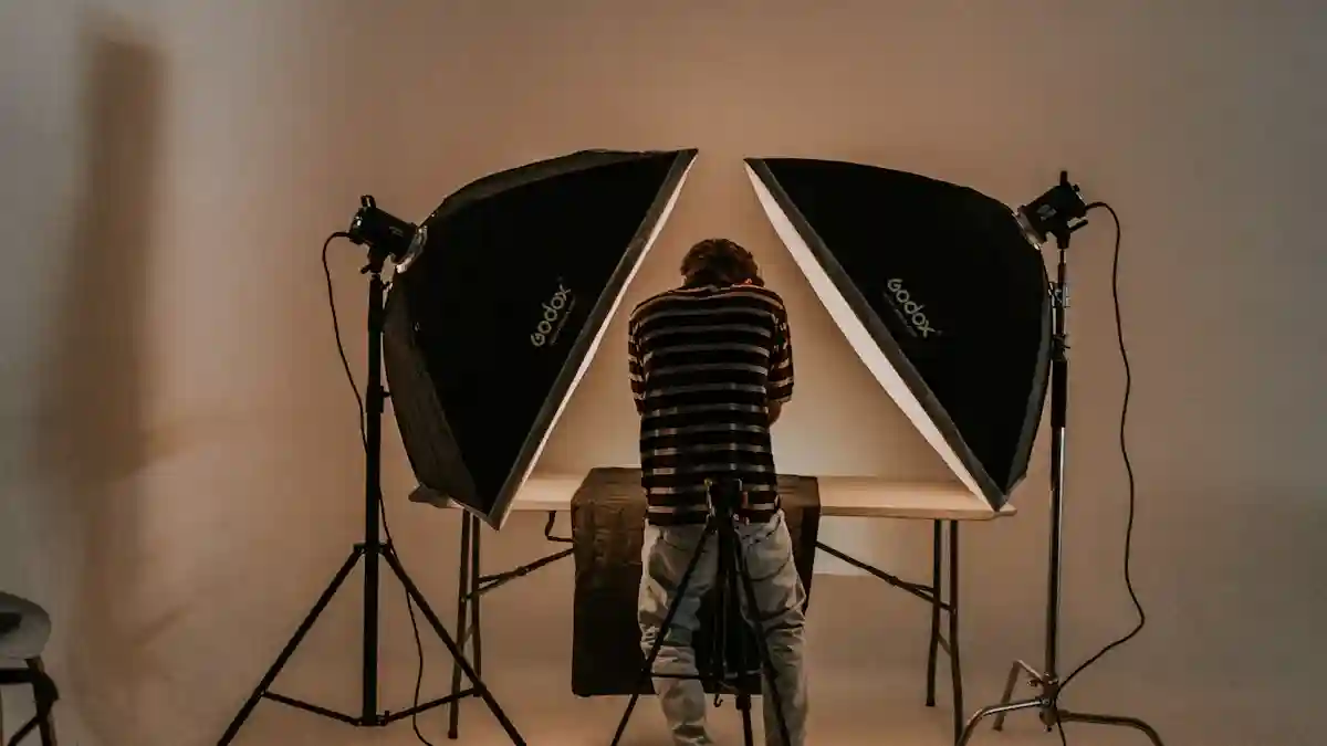 Photographer working with Godox softboxes in studio setting